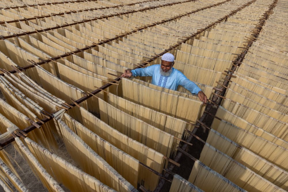 Man Drying Noodles by Azim Khan Ronnie — canvas wall art