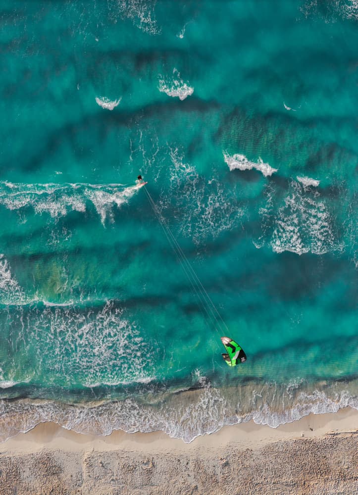 Kitesurfing Turquoise Beach by Erkan Camlilar — canvas wall art