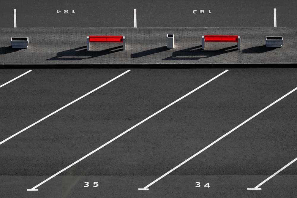 Red Benches Parking Lot by Hans-Wolfgang Hawerkamp — canvas wall art