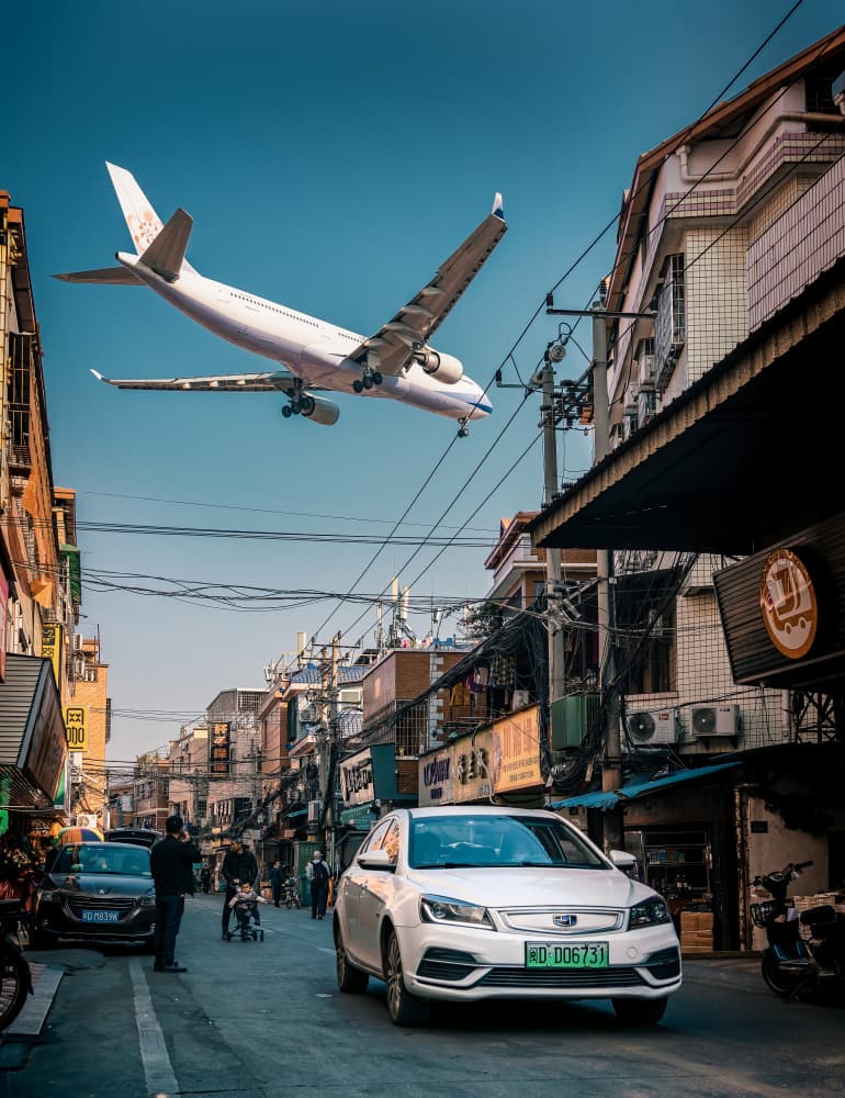 Airplane Over City Street by Yuan Cui — canvas wall art