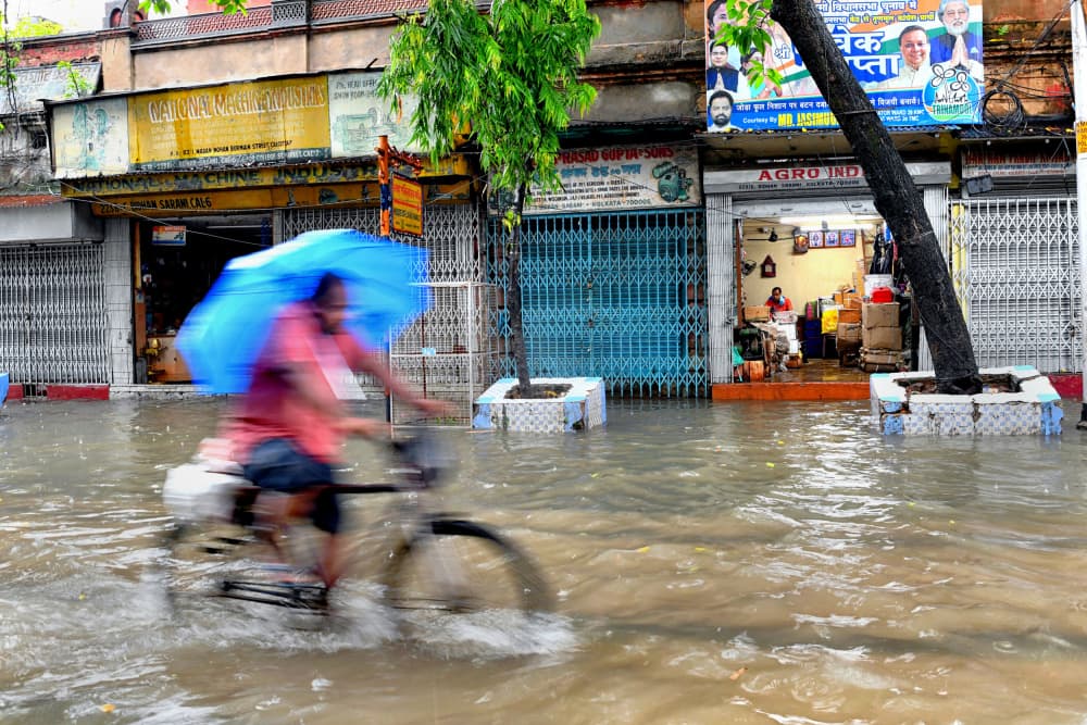 Monsoon Bicycle Ride by Shaibal Nandi — canvas wall art