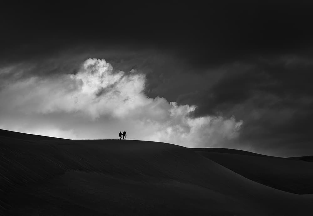 Couple on Desert Dunes by Shenshen Dou — canvas wall art