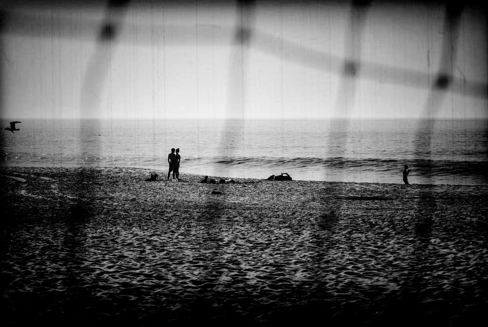 Beach Couple Through Grid by Milena Seita — canvas wall art