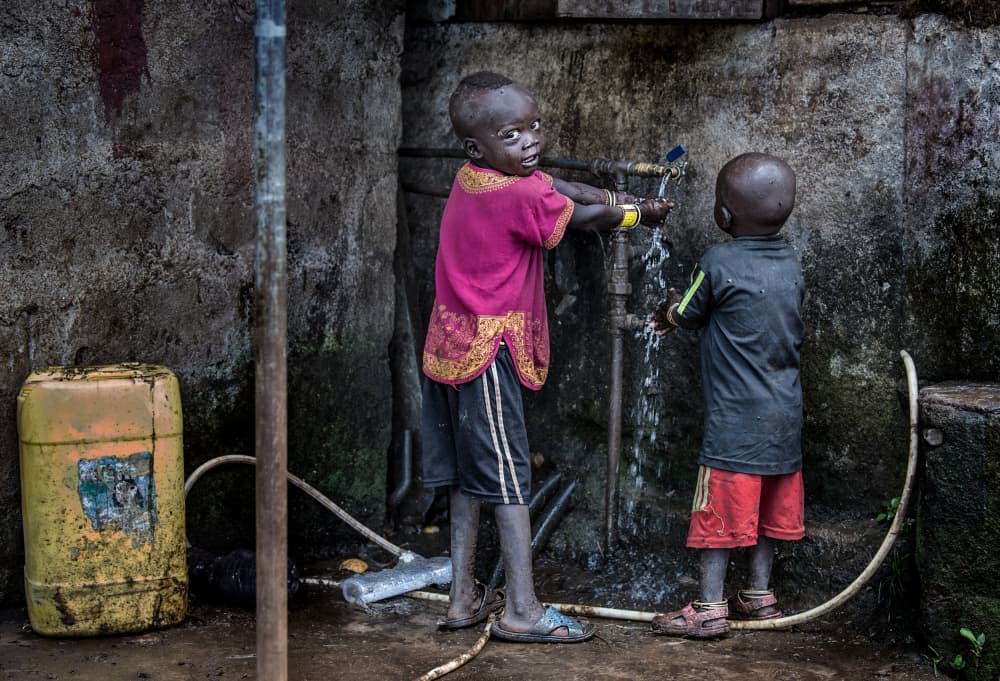 Children At The Water Tap by Joxe Inazio Kuesta Garmendia — canvas wall art