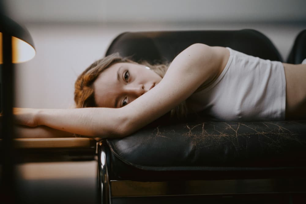 Pensive Woman On Couch by Steffen Lauterbach — canvas wall art