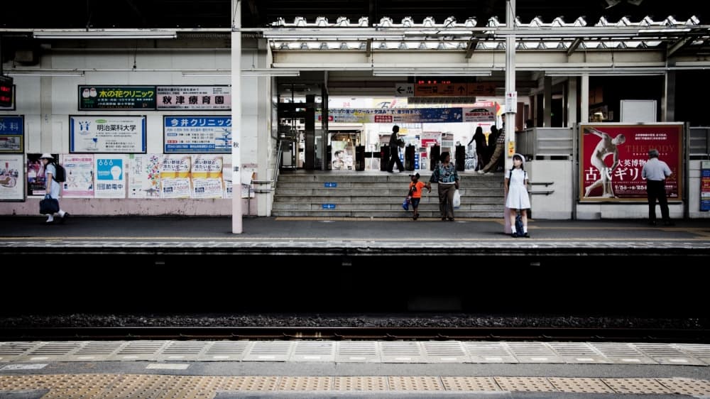Girl At Japanese Station by Kouji Tomihisa — canvas wall art