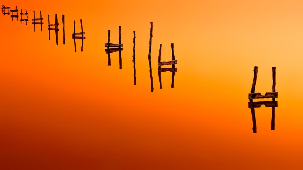 Orange Sunset Pilings by Zhecho Planinski — canvas wall art