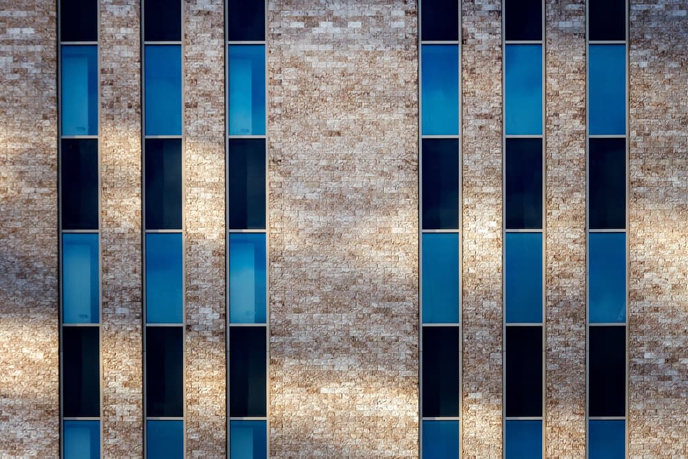 Blue Windows Brick Facade by Henk van Maastricht — canvas wall art