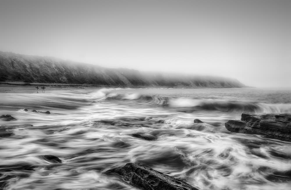 Misty Beach Surfers by Fran Osuna — canvas wall art