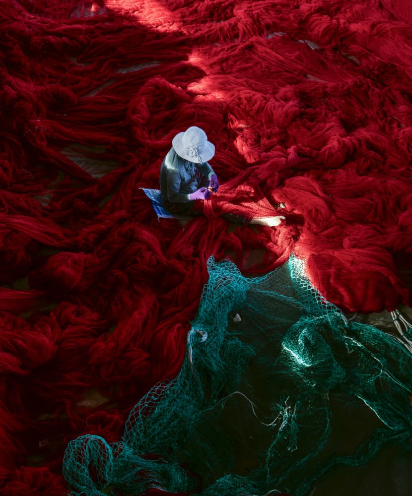 Worker Among Red Nets by Nguyen Tan Tuan — canvas wall art