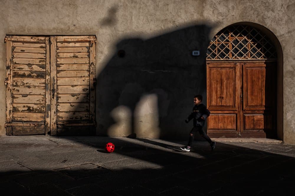 Boy Playing Street Soccer by Luca Domenichi — canvas wall art