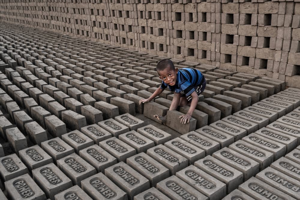 Smiling Child Brick Maker by Kuntal Biswas — canvas wall art
