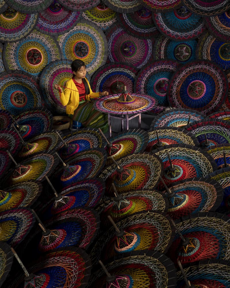 Artisan Weaving Colorful Umbrellas by Mahendra Bakle — canvas wall art