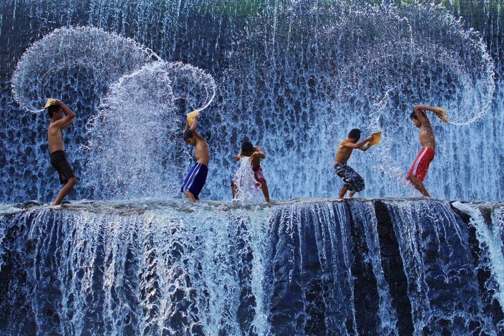 Boys Splashing Waterfall by Angela Muliani Hartojo — canvas wall art