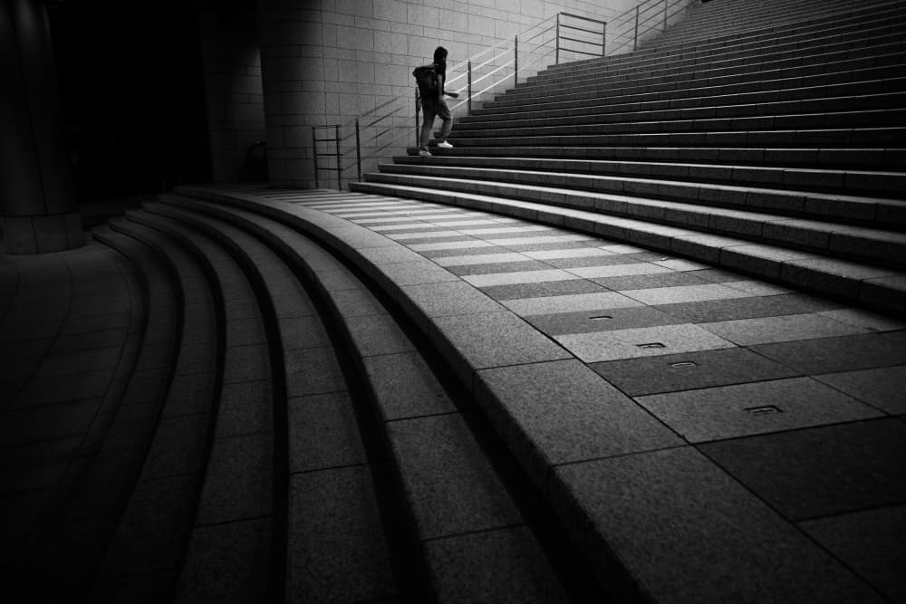 Man Ascending Urban Steps by Satoshi Hata — canvas wall art