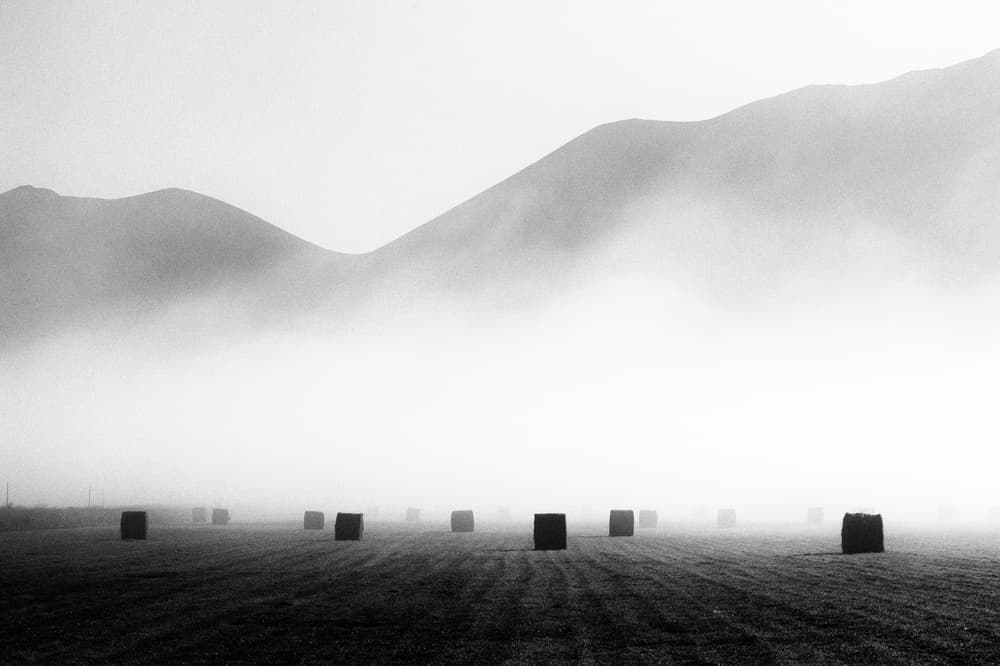 Misty Mountain Hay Bales by Riccardo Lucidi — canvas wall art