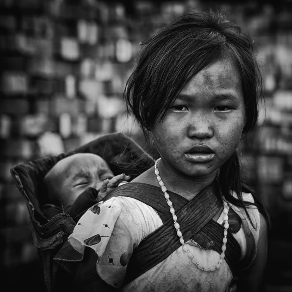 Young Girl Carrying Baby by Ahmed Abdulazim — canvas wall art