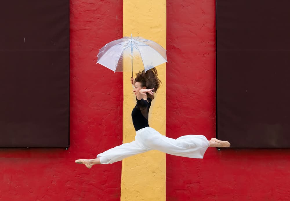Graceful Jump With Umbrella by Ken Liang — canvas wall art