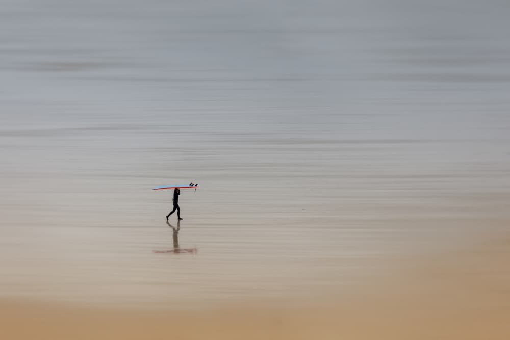 Lone Surfer's Quiet Walk by Uschi Hermann — canvas wall art