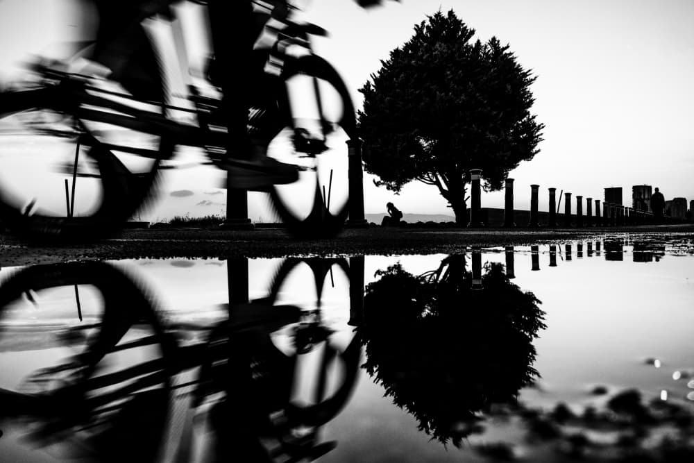 Blurred Cyclist Reflection by Ali Ayer — canvas wall art