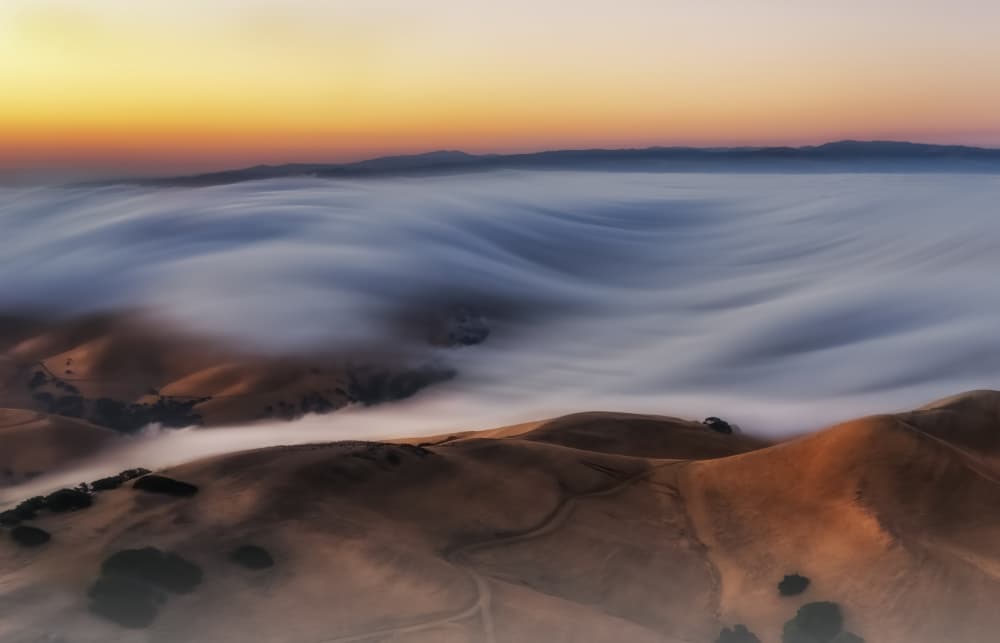 Sunrise Over Foggy Hills by Jenny Qiu — canvas wall art
