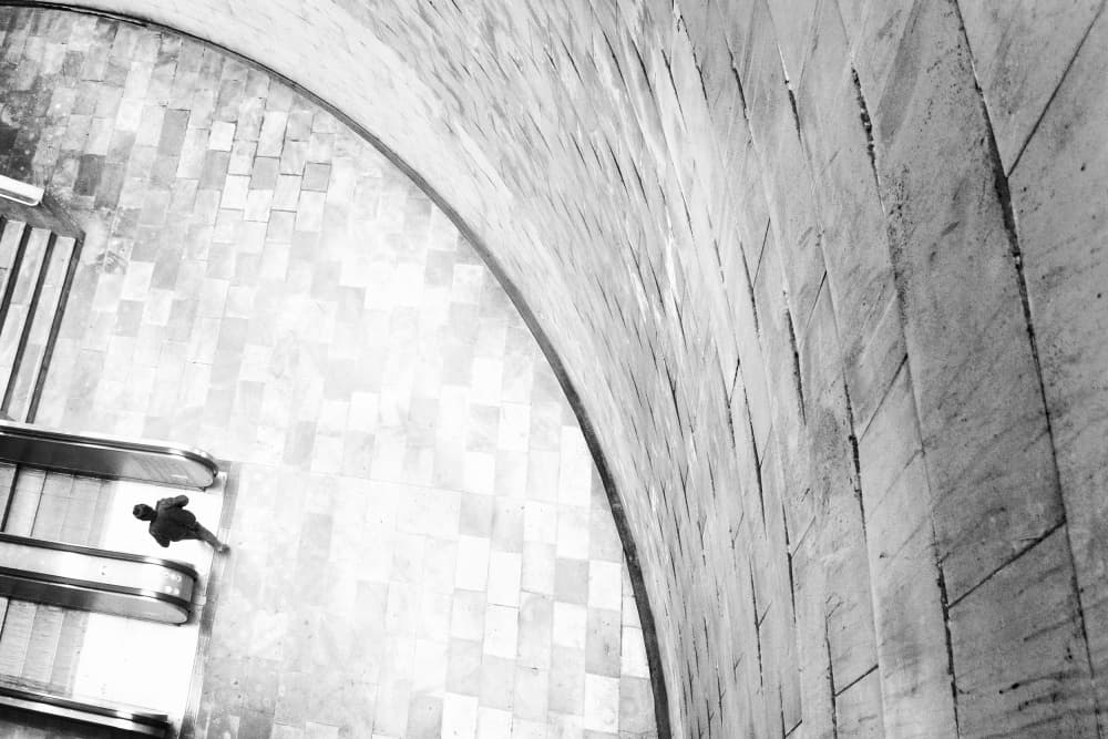 Lone Figure Escalator by Laura Mexia — canvas wall art