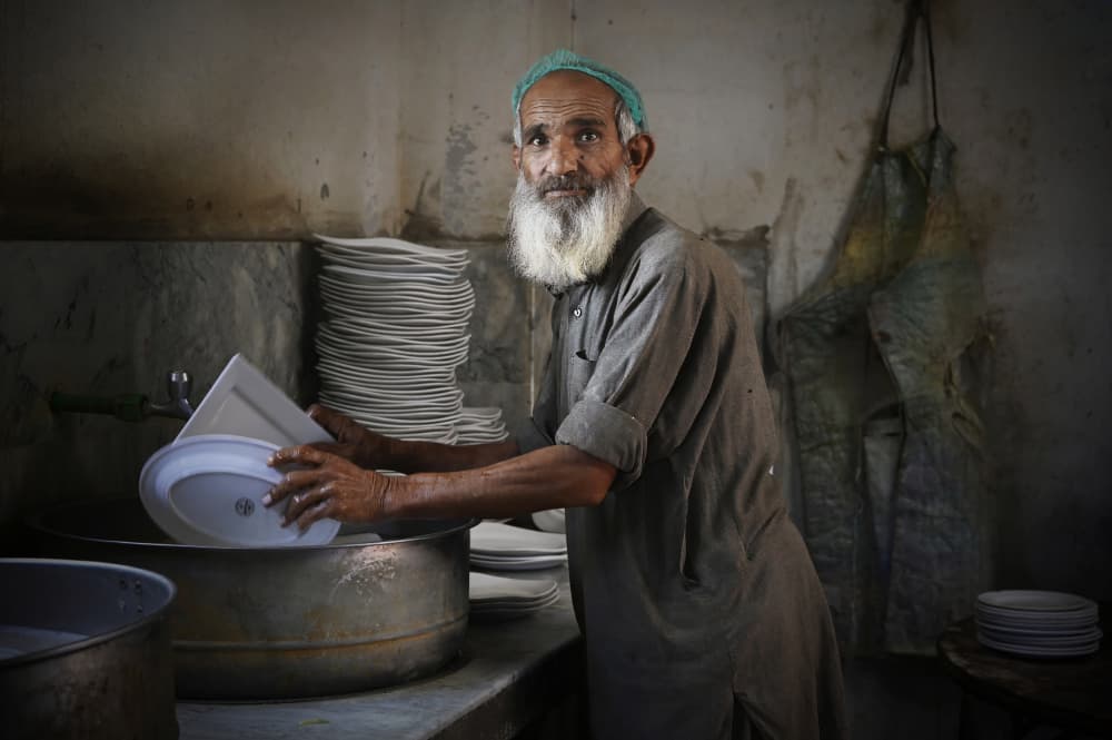 Old Man Washing Dishes by Irene Perovich — canvas wall art