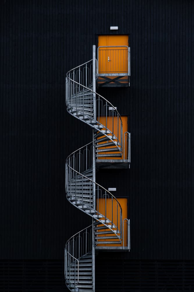 Orange Doors Spiral Staircase by Rolf Endermann — canvas wall art