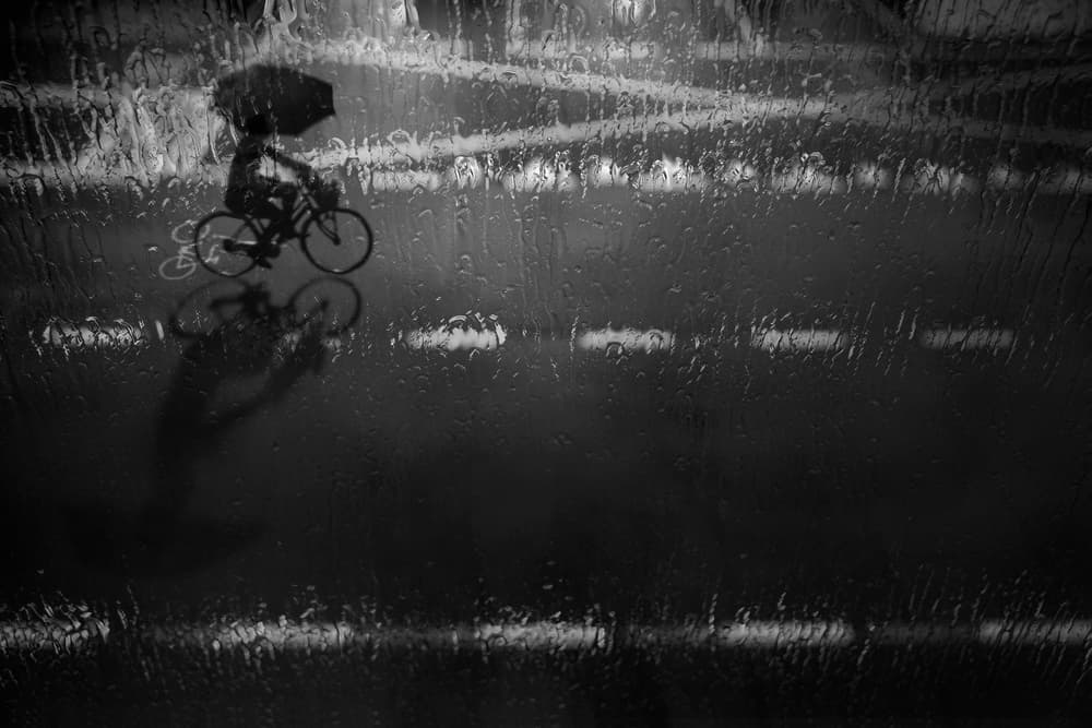 Rainy Night Cyclist by Ekkachai Khemkum — canvas wall art