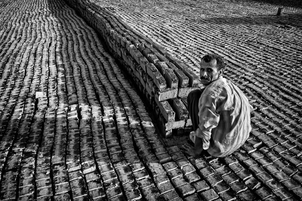 Manual Brick Worker by Mohammadreza Momeni — canvas wall art