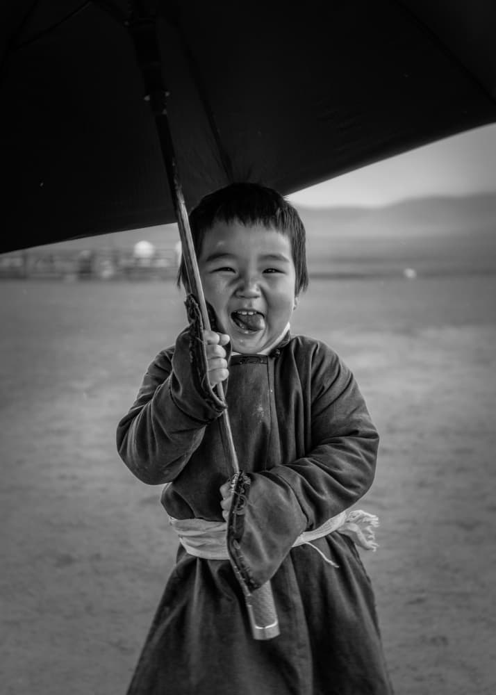 Playful Child With Umbrella by ADIREK M — canvas wall art