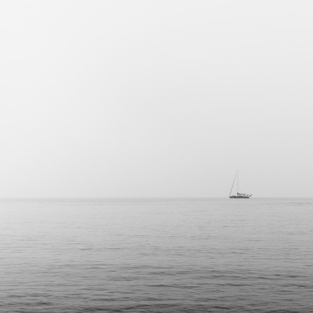 Solitary Sailboat At Sea by Lynann Colligan — canvas wall art