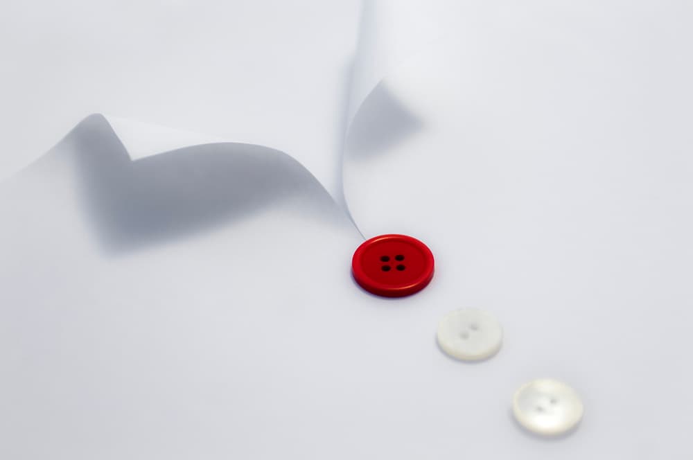 Red Button White Paper by Jorge Ruiz Dueso — canvas wall art