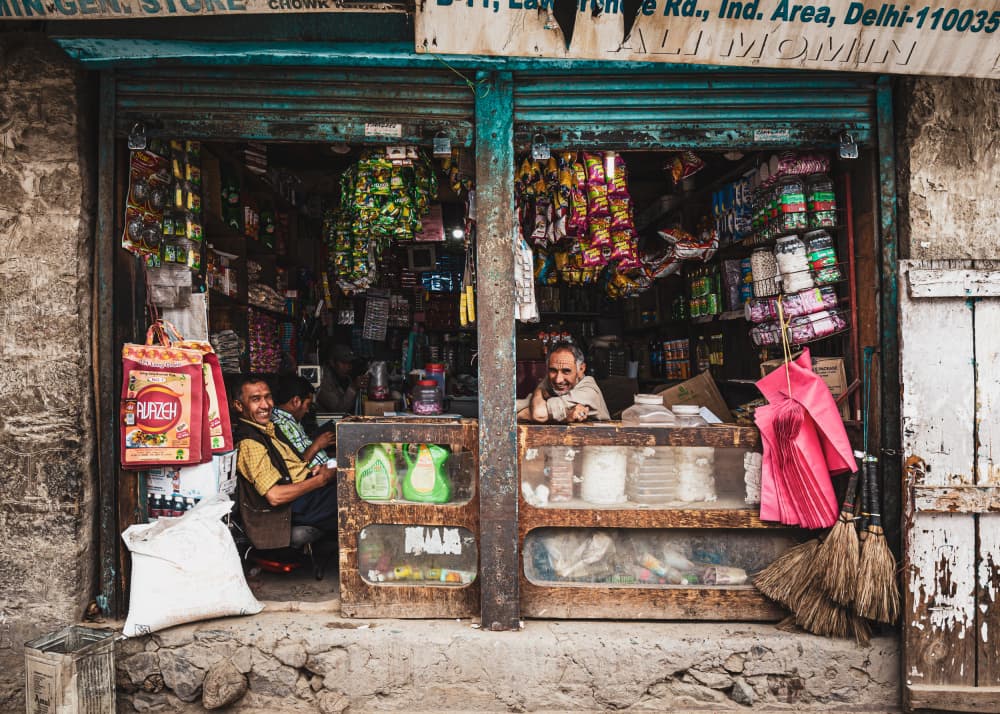 Smiling Shopkeeper India by Marco Tagliarino — canvas wall art