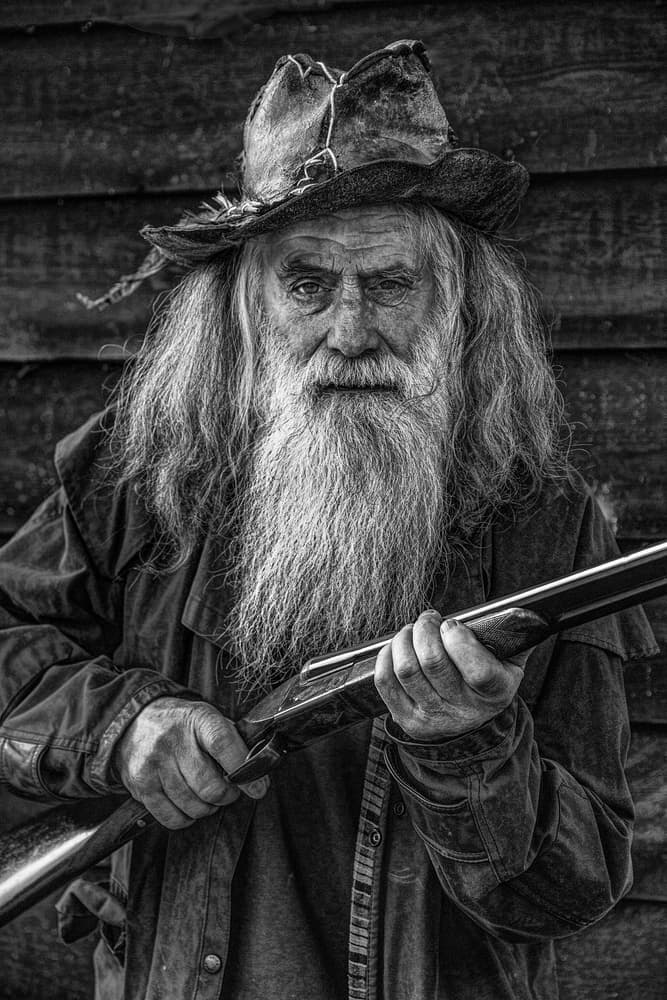 Grizzled Man with Shotgun by Tony Mearman — canvas wall art