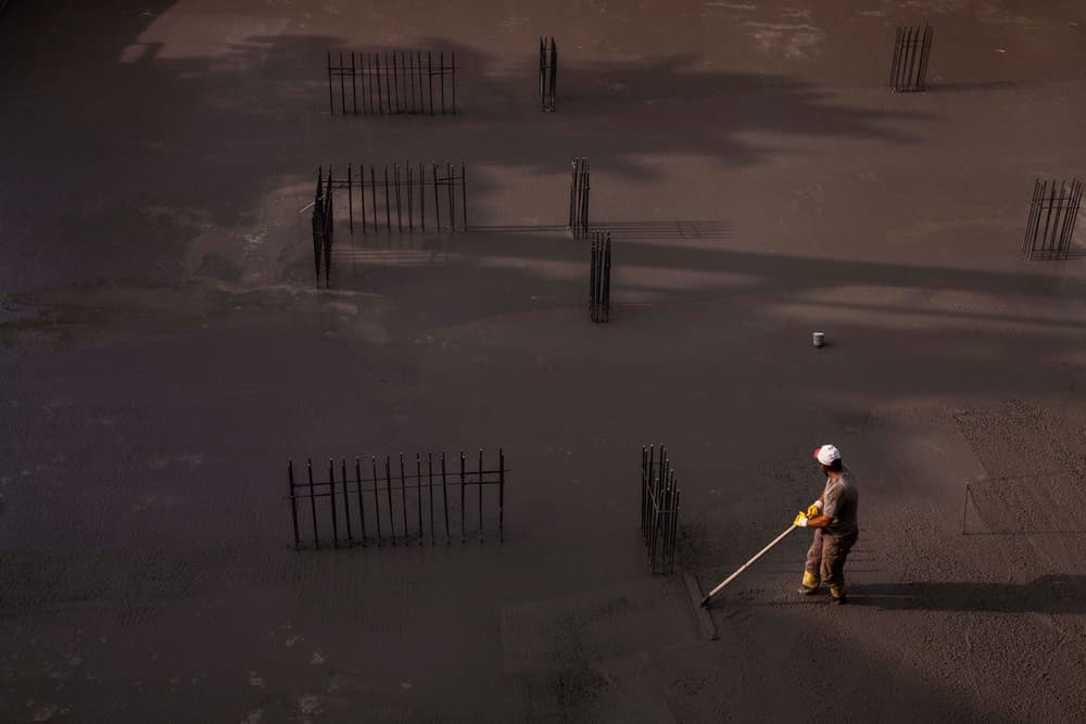 Worker Smoothing Concrete by Ramiz Sahin — canvas wall art