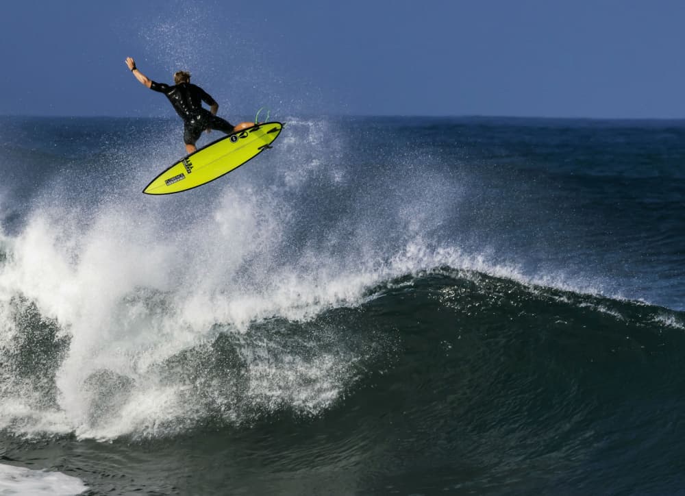 Surfer Takes Flight by yibing Nie — canvas wall art