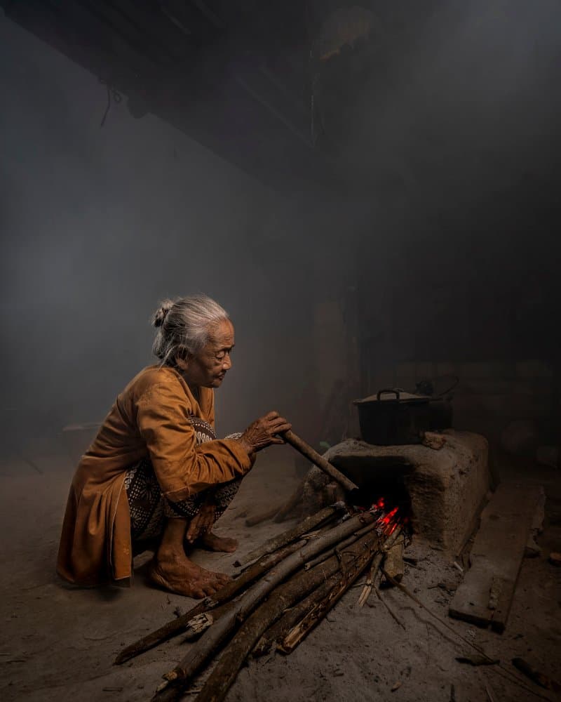 Elderly Woman Cooking Fire by octavandy — canvas wall art