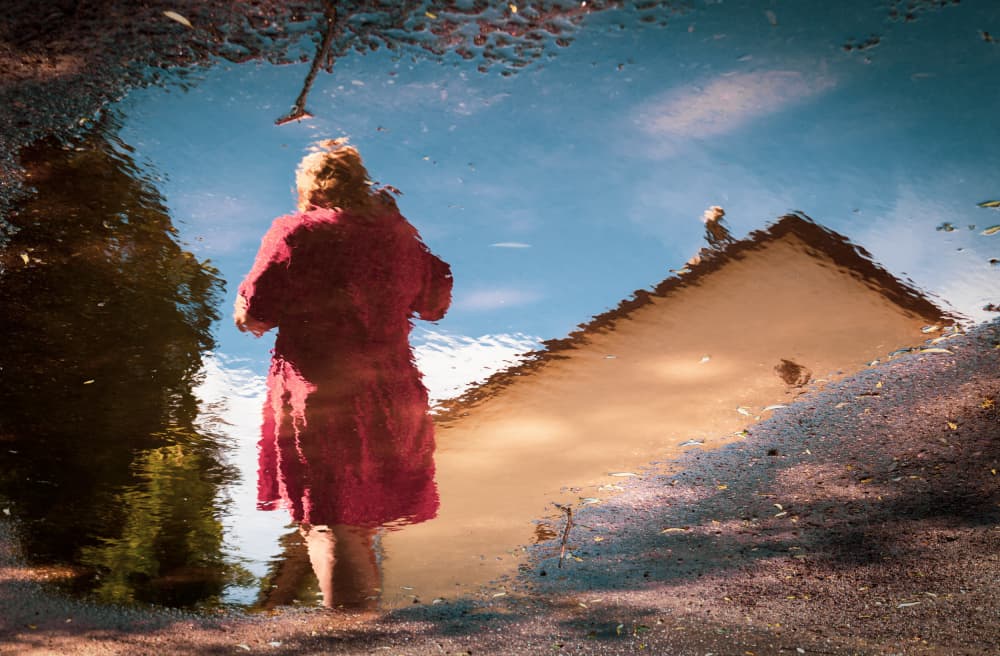 Red Dress Puddle Reflection by Ilze Ozola — canvas wall art