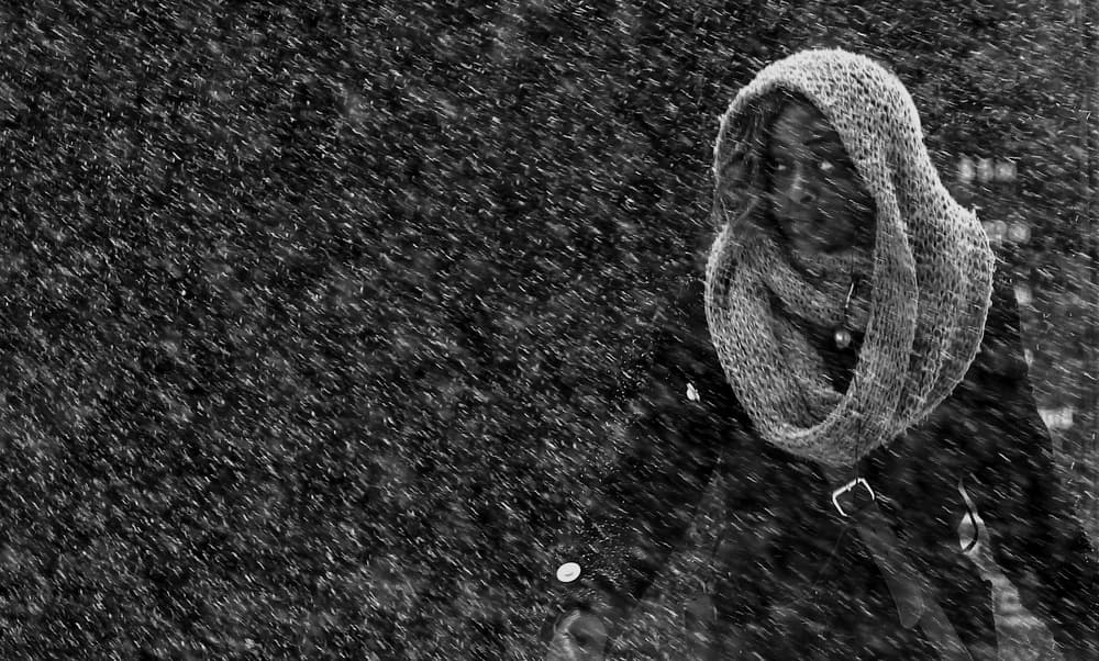 Hooded Figure in Snowfall by Jian Wang — canvas wall art