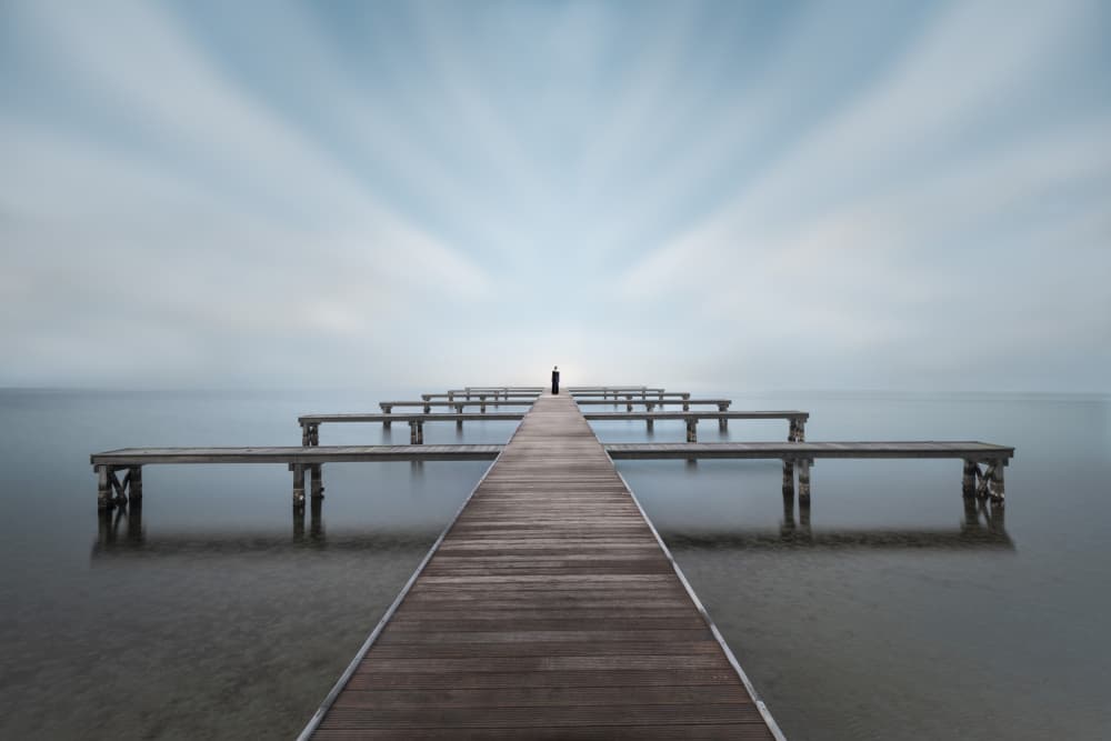 Solitary Figure on Pier by Bart Michiels — canvas wall art