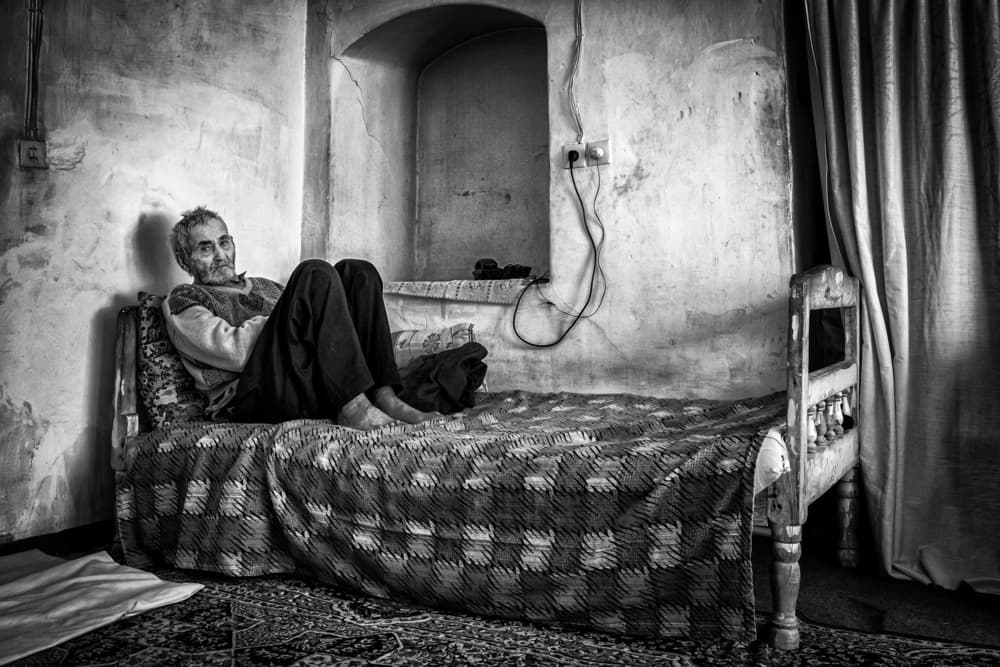 Thoughtful Man on Bed by Mohammadreza Momeni — canvas wall art