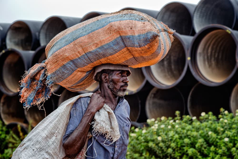 Man Carrying Heavy Load by Lorenzo Grifantini — canvas wall art