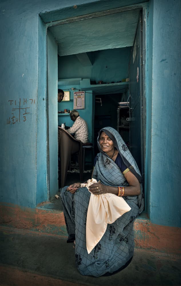 Smiling Woman Blue Doorway by Waldemar Szmidt — canvas wall art