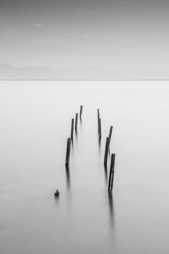 Serene Pier Pilings by Catalin Baican — canvas wall art