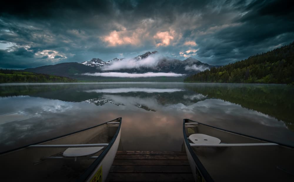 Canoes On Mountain Lake by Bing Li — canvas wall art