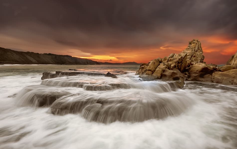 Dramatic Coastal Sunset by Mikel Lastra — canvas wall art