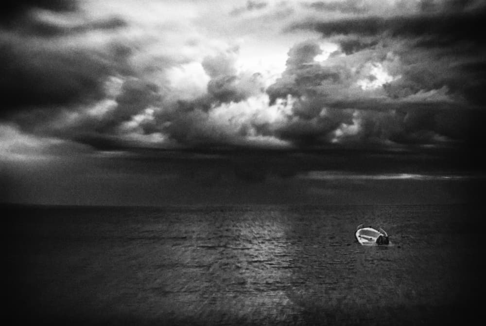 Solitary Boat Dark Clouds by Codrin Lupei — canvas wall art