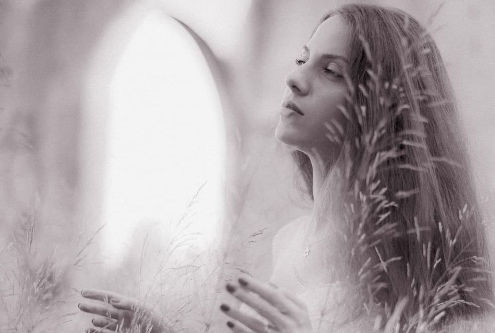 Serene Woman in Grass by DAVID MINSTER — canvas wall art