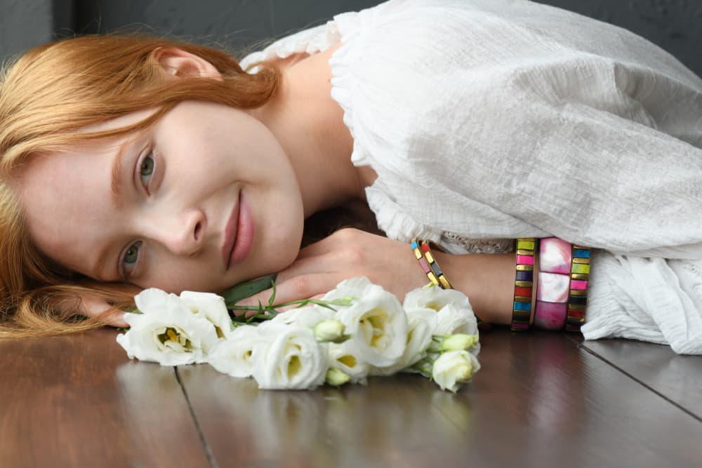 Smiling Redhead with Flowers by Yoram GIL — canvas wall art